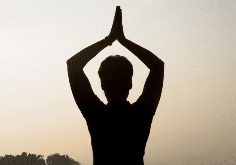 A person is doing yoga in the evening.